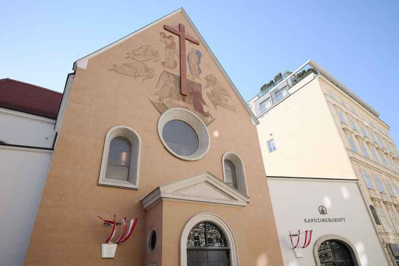Exterior view of Capuchin Church with Viennese flags