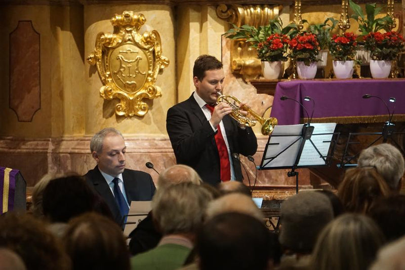 Trumpet player tuning his instrument in preparation for a Christmas concert in Vienna.